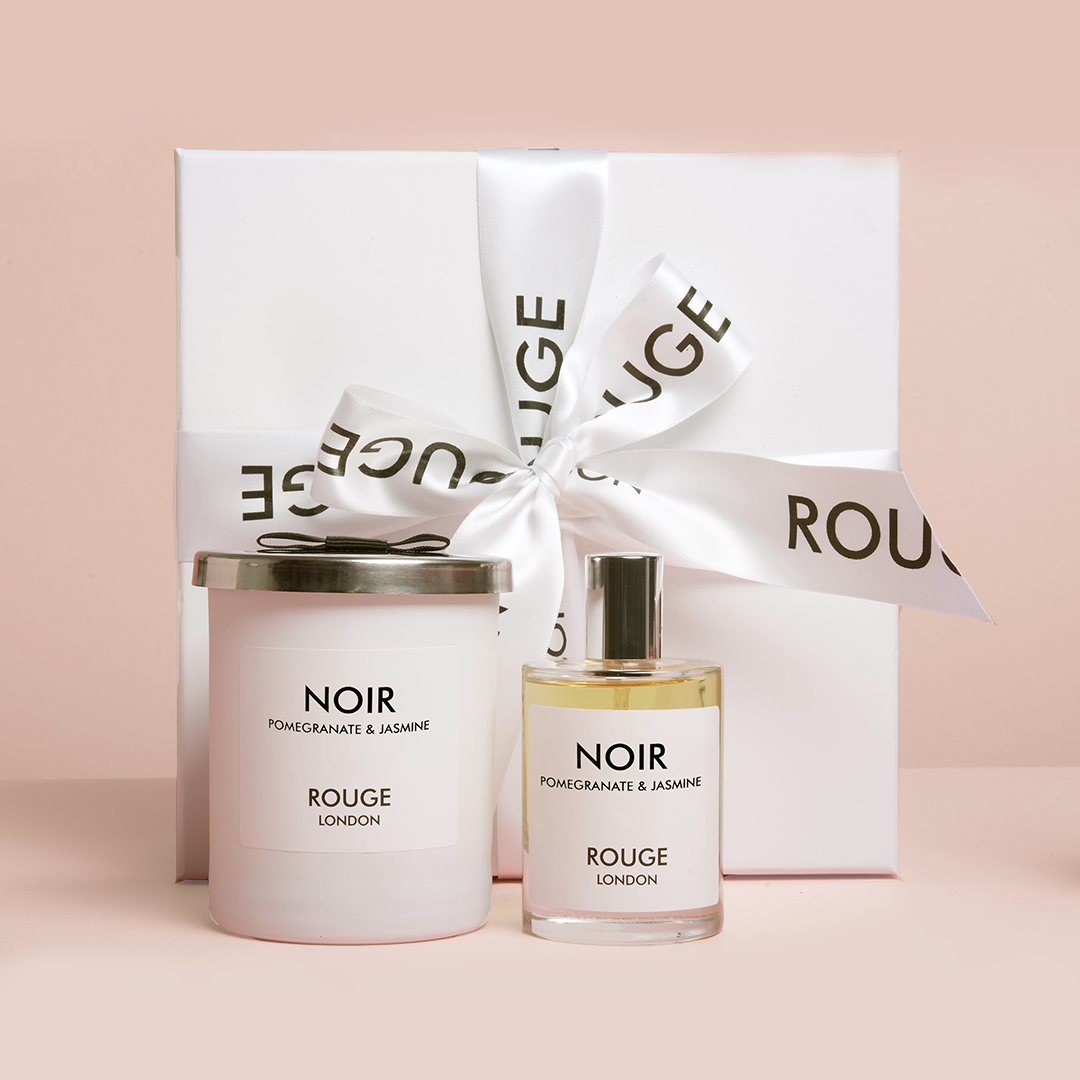 A luxury candle and room spray set, with the candle labeled 'NOIR' and the room spray labeled 'ROUGE LONDON'