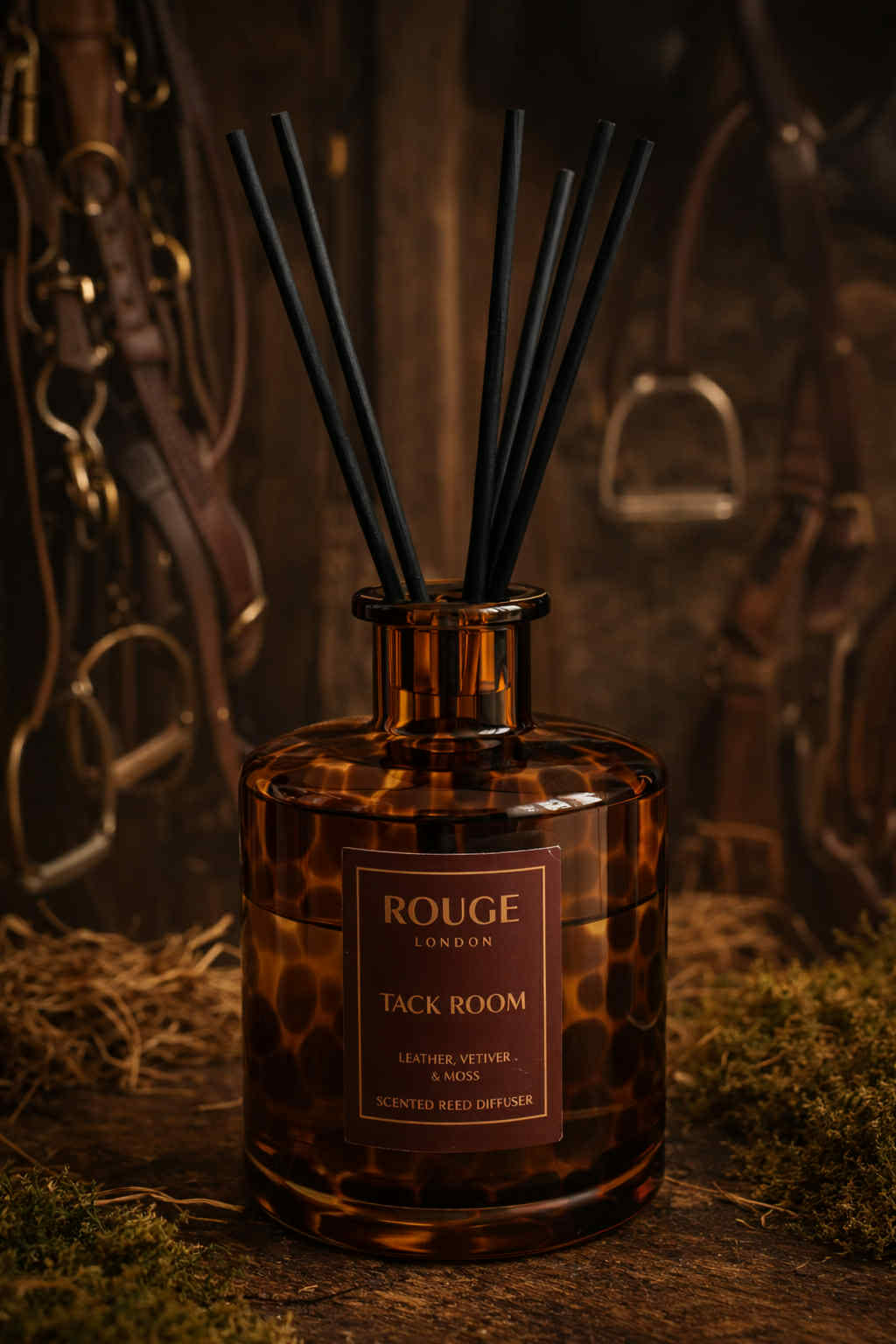 Tack Room reed diffuser in a dark, rustic setting