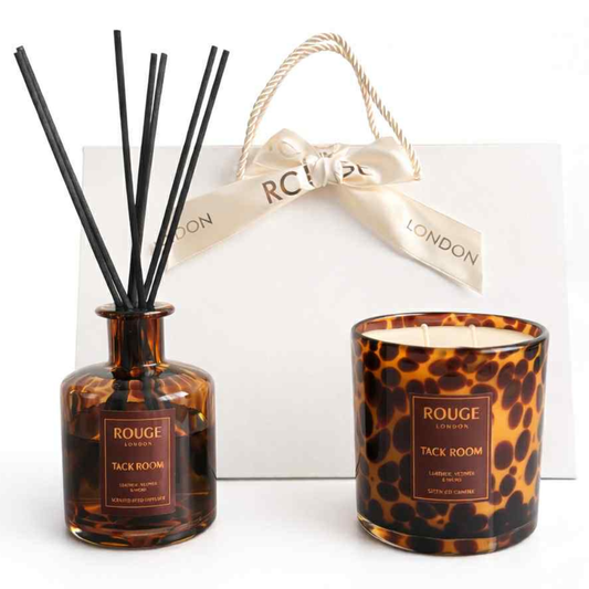 Tack Room reed diffuser and 2 wick candle with tortoiseshell pattern, with handbag style gift box behind
